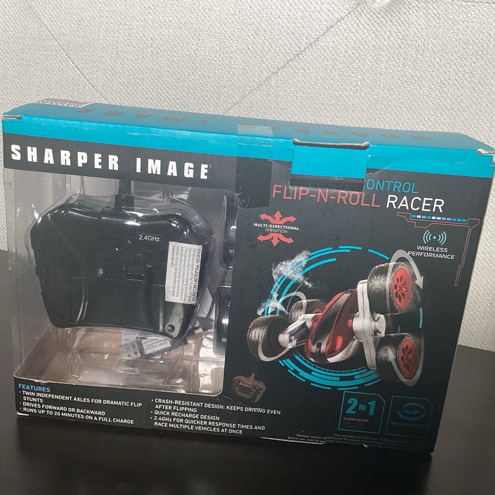 Sharper image, remote control, flip and roll racer